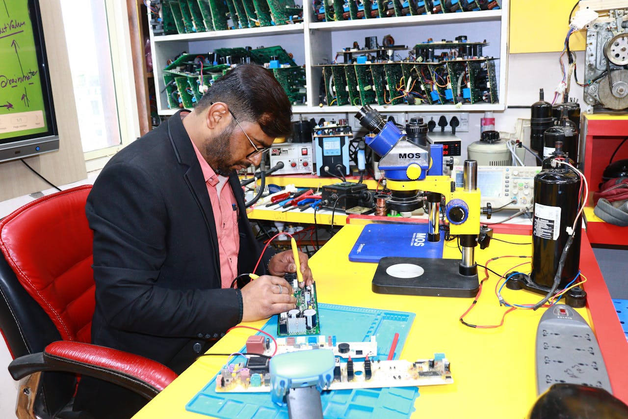 A focused technician repairs a circuit board in a high-tech electronics workshop.